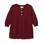 Verleihen Sie Ihrem Baby mit diesem Strickkleid in bordeauxe rot einen schicken und bequemen Look. Das weiche Material sorgt für ein angenehmes Tragegefühl, während das auffällige Design für bewundernde Blicke sorgt. Perfekt für jeden Anlass und einfach anzuziehen.