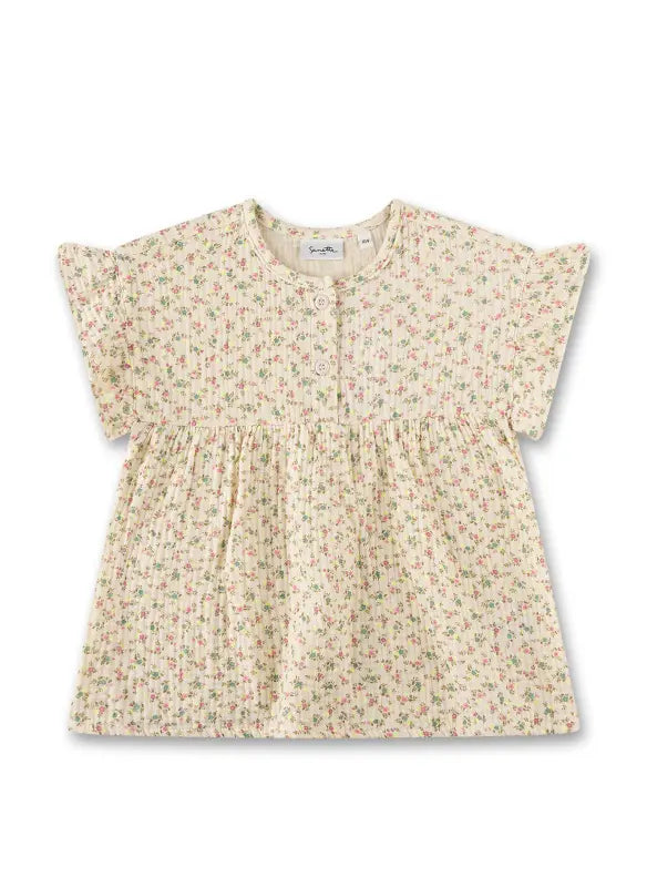 Diese beige Bluse von Sanetta besticht durch ihr zartes Blumenmuster und verleiht jedem Outfit eine feminine Note.