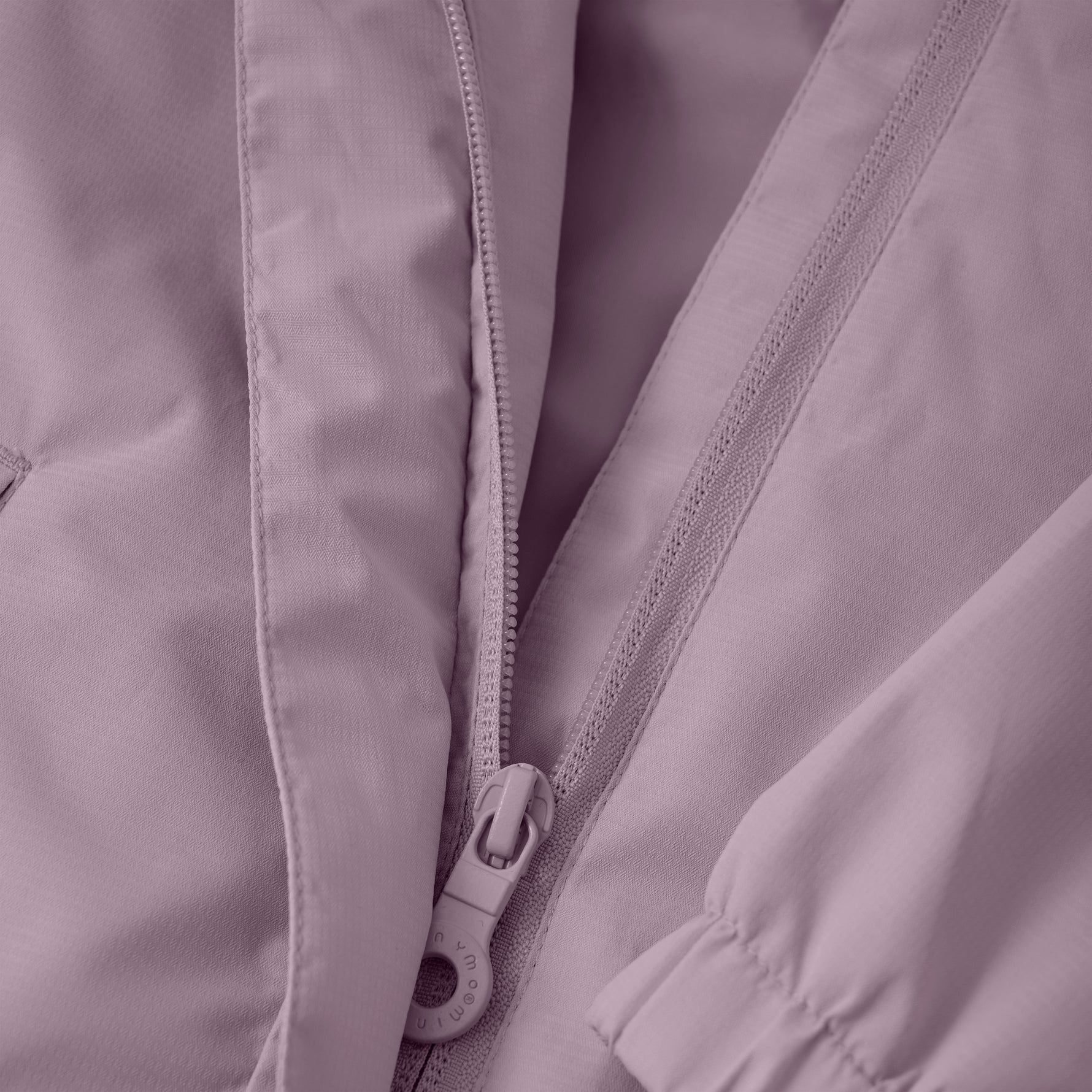 Diese Regenjacke von MINYMO präsentiert sich in einem eleganten Lilaton und bietet zuverlässigen Schutz bei nassem Wetter.