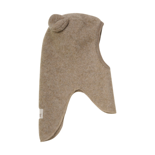 Diese beige Wollhaube mit Ohren von Huttelihut verbindet kuschelige Wärme mit verspieltem Design – perfekt, um stilvoll durch kalte Tage zu kommen.