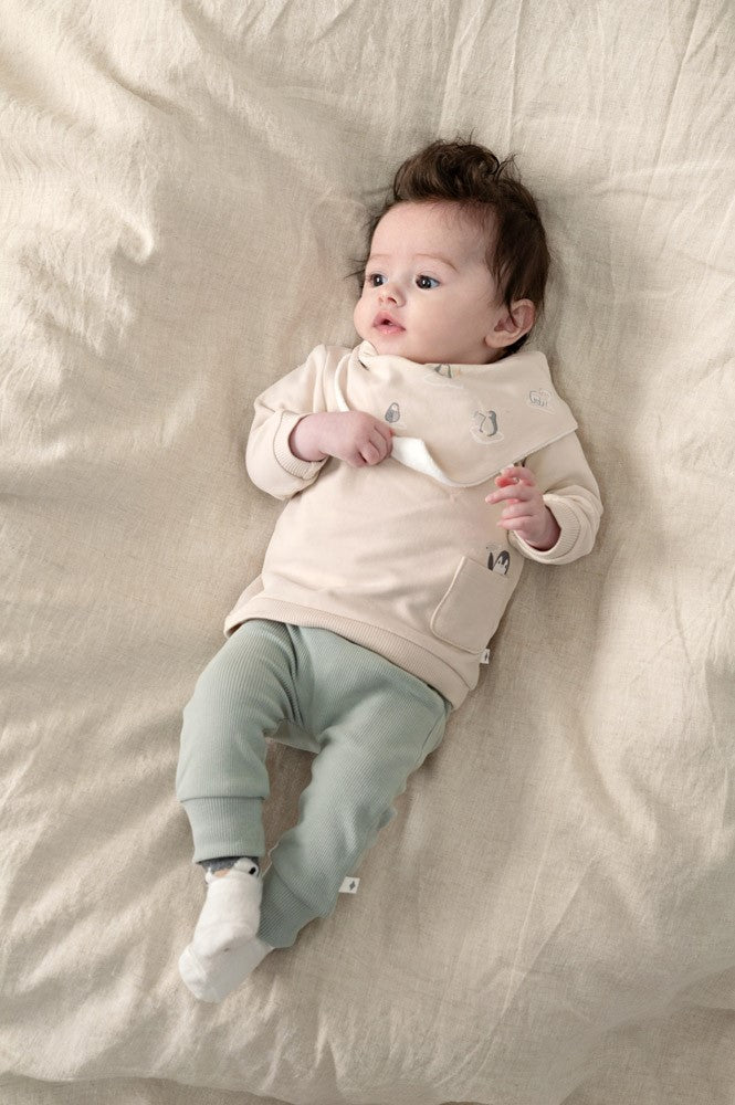 Dieser kuschelweiche Schal von Feetje besticht durch sein verspieltes Pinguin-Motiv und überzeugt mit hochwertigen Materialien. Die Kombination aus Single Jersey und Terry Towel sorgt für optimale Wärmespeicherung und angenehmen Tragekomfort. Perfekt für kleine Abenteurer in der kalten Jahreszeit – ein treuer Begleiter für jedes Outdoor-Abenteuer.