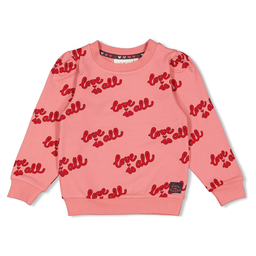 Dieser rosa Pullover aus der Queen Of Hearts Kollektion von Jubel besticht durch seinen auffälligen roten All-Over-Print und verleiht jedem Outfit einen einzigartigen Charme.